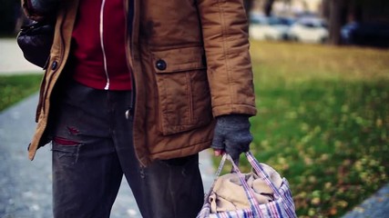 Wall Mural - A midsection of homeless beggar man walking outdoors in park. Slow motion.