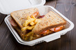 Sandwich with french fries packed in plastic box for lunch