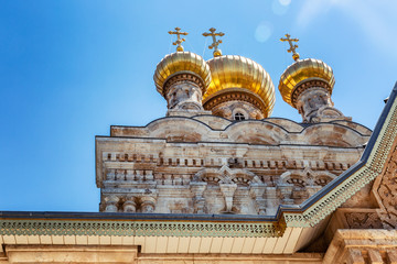 Wall Mural - Golden domes of an old orthodox temple on a background of bright blue sky