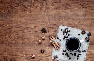 cup of coffee and beans on wooden background