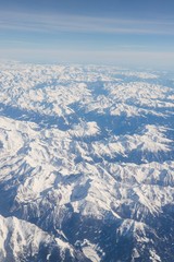 Wall Mural - Aerial view of snow covered mountains - snowy mountain peaks - high mountains - Alps