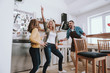 © Yakobchuk Olena - Cheerful parents having fun with their cute daughter at home