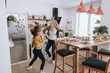 © Yakobchuk Olena - Cheerful mother and daughter having fun at home
