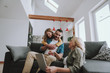 © Yakobchuk Olena - Lovely family watching videos on laptop at home