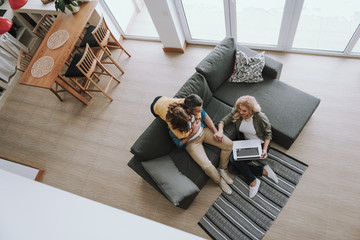 Wall Mural - Loving parents spending time with their cute daughter at home