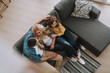 © Yakobchuk Olena - Young man sitting on couch with his beautiful wife and daughter