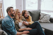 © Yakobchuk Olena - Happy family resting on comfortable couch at home