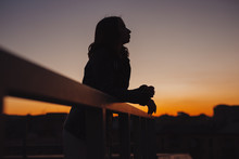 Silhouette Of Woman Thinking About Future At Sunset In City