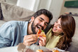 © ivanko80 - Young couple eating pizza at home