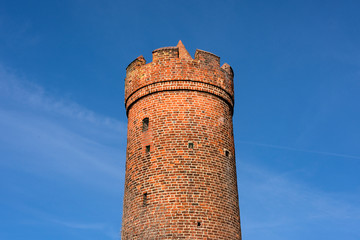 Germany, Brandenburg, Jueterbog, Frauentor: Upper part close up of historic round tower as part of the old city wall fortification in the German small town center - concept architecture history