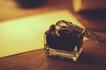 Wall Mural - closeup of vintage quill pen and ink jar on wooden table