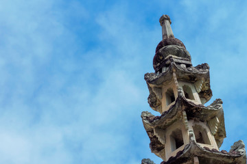 Wall Mural - Old chinese pagoda is wat kalayanamit woramahawiharn with a background is blue sky with cloudy