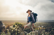 © Jacob Lund - Female hiker enjoying the view standing on a hill