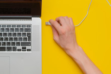 Persons Hand Insert Usb Wire In A Laptop Isolated B