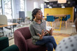 Job interview in co-working space by recruiter. Black african woman in her twenties being interviewed for a job position