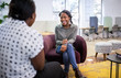 Job interview in co-working space by recruiter. Black african woman in her twenties being interviewed by a woman employer