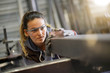 Leinwandbild Motiv Woman apprentice training in metalwork workshop