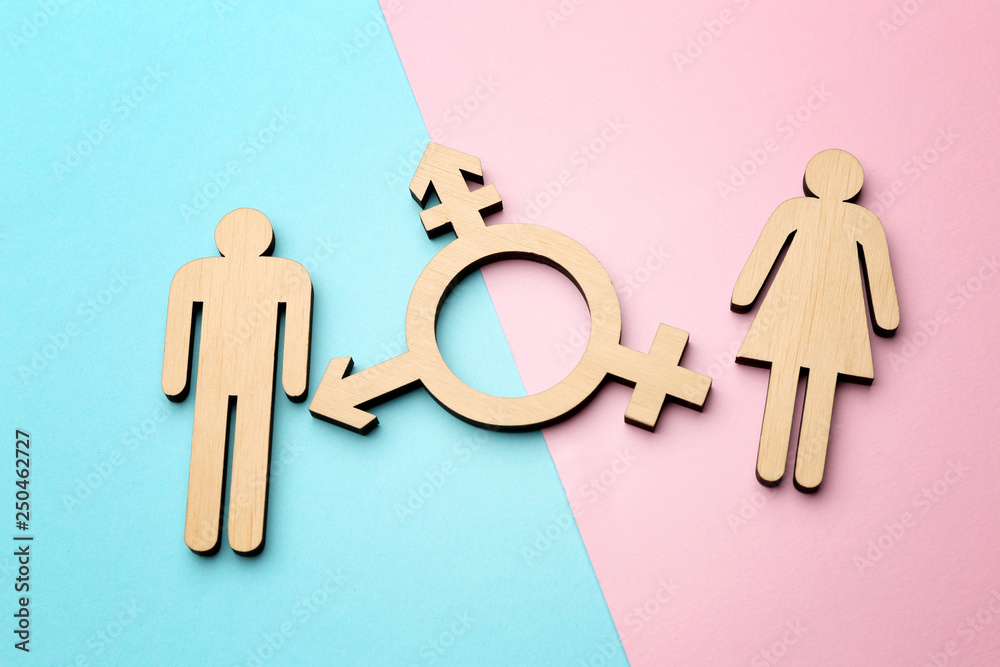 Female and male figures with symbol of transgender on color background - obrazy, fototapety, plakaty 