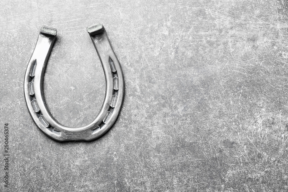 Horseshoe for luck on grey background