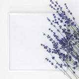 Fototapeta Lawenda - Lavender flowers and frame and space for text on white table. Top view.