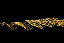 Long Exposure, Light Painting Photography.  Abstract Neon Metallic Yellow Gold Ripples And Waves Pattern, Vibrant Color Against A Black Background