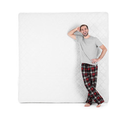 Wall Mural - Young man with comfortable mattress isolated on white