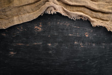 Old Linen Fabric On A Black Wooden Background.
