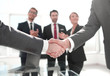 © ASDF - business handshake over blurry background office