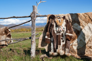 national clothes made of reindeer skins and reindeer skins on the background