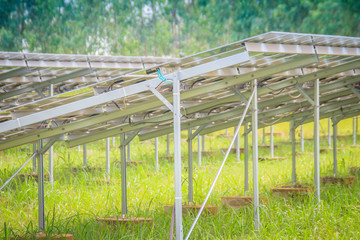 Large scale solar farm, mega photovoltaic power plant in green grass field.