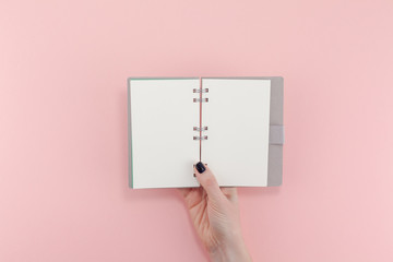 Wall Mural - Woman hands with blank notepad mockup