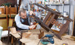 © JackF - Carpenter repairing antique chair