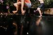 © Cavan Images - Low section of playful sisters jumping on trampoline