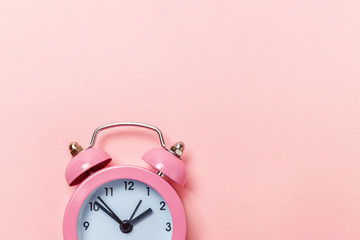 Ringing twin bell vintage classic alarm clock Isolated on pink pastel colorful trendy background. Rest hours time of life good morning night wake up awake concept. Flat lay top view copy space