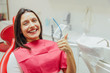 © Andrii - Portrait of a happy dentist in a dentist's chair. During this smiles and shows a gesture with a thumb up the class, well.
