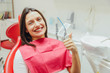 © Andrii - Portrait of a happy dentist in a dentist's chair. During this smiles and shows a gesture with a thumb up the class, well.