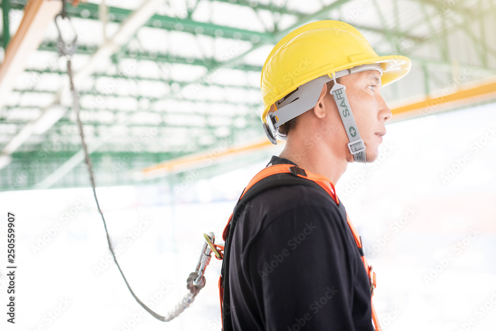 Industrial Worker with safety protective equipment loop hanging on the ...