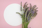 Fototapeta Lawenda - lavender flower bouquet and white  round plate on a pink background.top view, copy space.