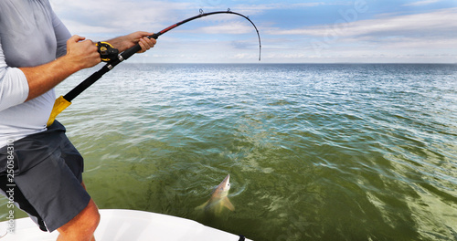 Fotografía Sports fishing fisherman man pulling off spinner shark