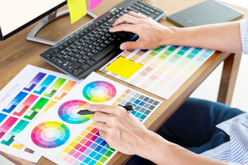 Poster - graphic designer or creative holding mouse and do his work material color pantone swatch samples art