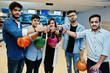 © AS Photo Family - Group of five south asian peoples having rest and fun at bowling club. Clinking cold soda drinks from glass bottles and bowling balls at hands.