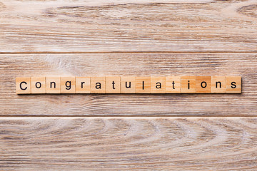congratulations word written on wood block. congratulations text on wooden table for your desing, concept