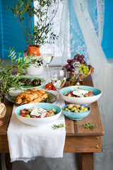 traditional Greek lunch: salad with feta, souvlaki, olives and wine