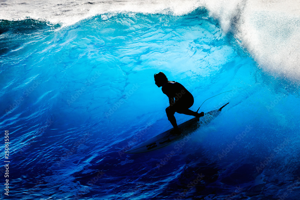 Silhouette surfer riding the big blue surf waves on the island Madeira, Portugal, a popular surfing tourist destination - obrazy, fototapety, plakaty 