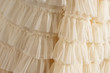 Tulle beige luxury dress with ruffles. Closeup detailed background.