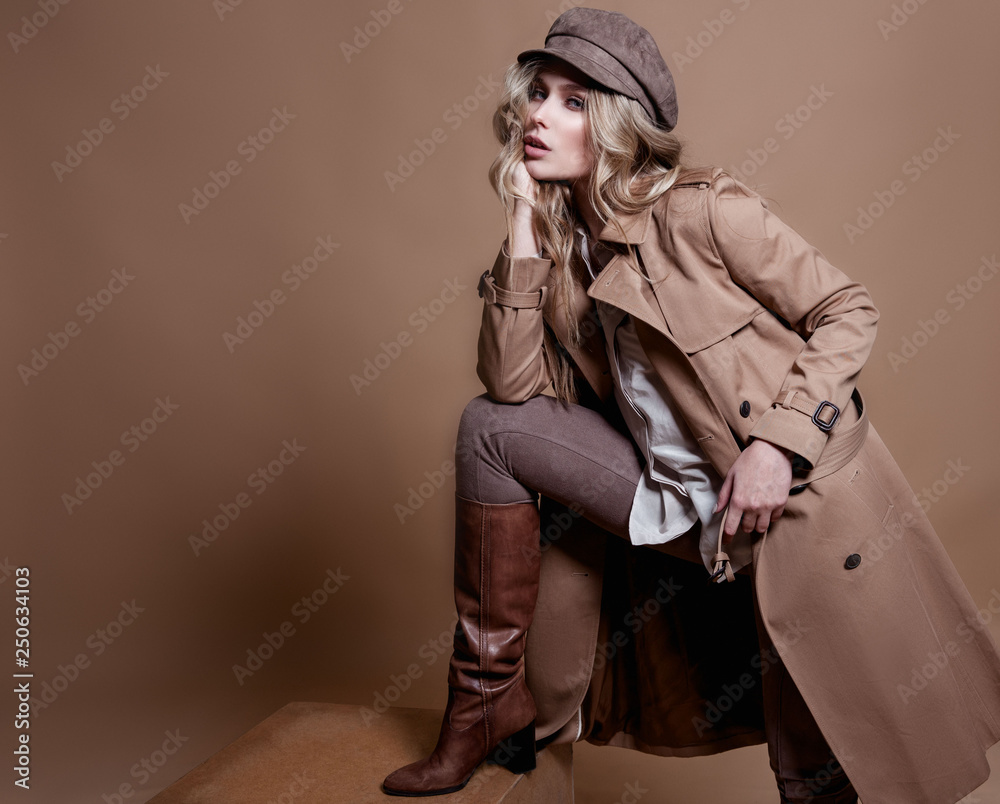 High fashion portrait of stylish blond woman in total beige look over beige background. - obrazy, fototapety, plakaty 