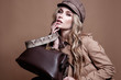 © svitlychnaja - High fashion portrait of stylish dlond woman in total beige look with leather bag and animal  print belt.