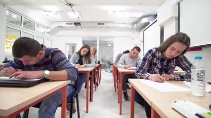 Wall Mural - students studying in a classroom, taking a test