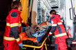 © LIGHTFIELD STUDIOS - Paramedics transportating patient on gurney in ambulance car