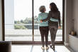 © Mangostar - Rear view of happy mother and daughter standing embracing